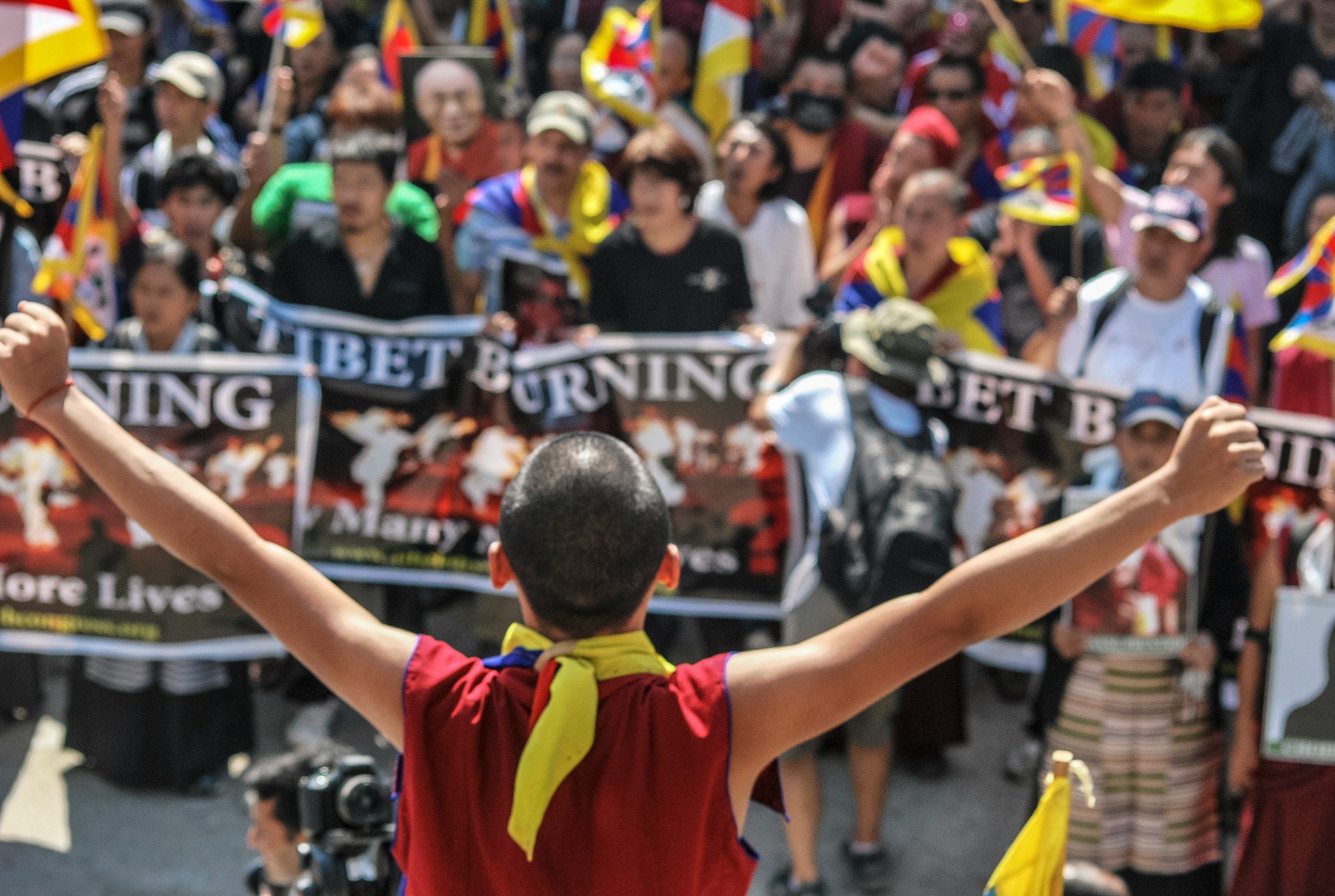 man raising to hands while facing crowd